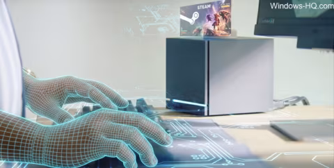 Two hands with wireframe outlines gesture toward a modern black and white computer tower and a visible Steam interface on a desk.