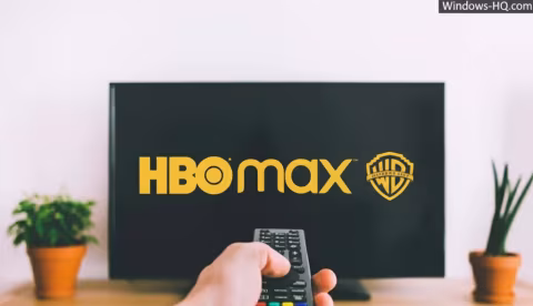 A television screen displaying the HBO Max logo and a remote control nearby.