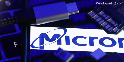 Close-up of computer components, including a blue USB drive, a printed sticker, and RAM modules.