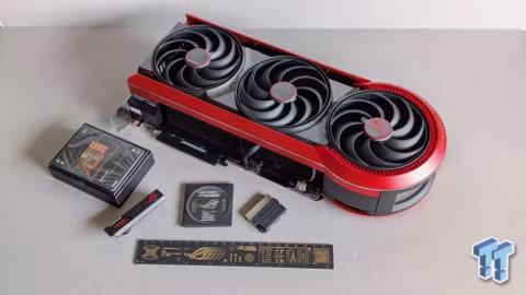 Graphics card featuring three visible cooling fans, resting on a light gray surface.