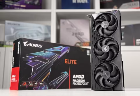 Stack of two black graphics cards, each with six visible fans, displayed on a white table.
