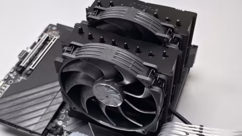 A stack of black CPU coolers with fans and heatsinks, shown against a white background.
