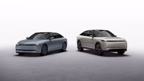 Two futuristic electric vehicles are displayed indoors against a plain white background.