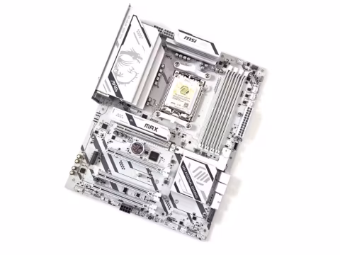 Close-up view of a silver and black computer motherboard with various connectors and chips.
