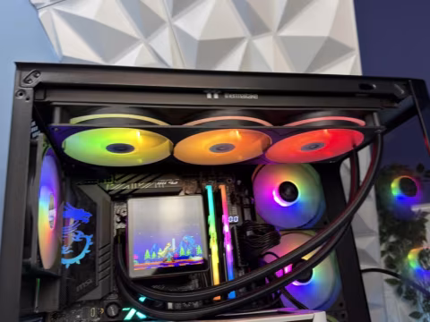 A computer case with several installed hardware components, including multiple radiator fans.