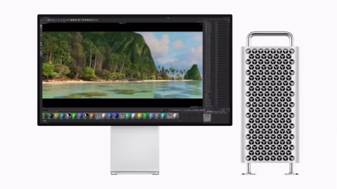 A white Mac Pro computer display and a vertical white pegboard with black diamond shapes.