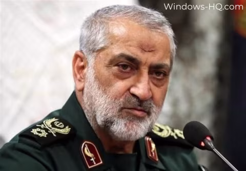 Middle-aged man with a beard in a military uniform, speaking at a press conference.