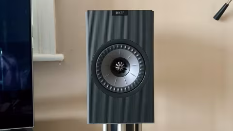 Close-up view of a rectangular black speaker with a circular woofer.