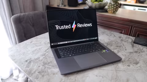 Laptop showing a web page titled 'Trusted Reviews' on a table.