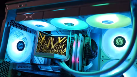 Close-up view of computer internal components including fans, cooling elements, and cabling.