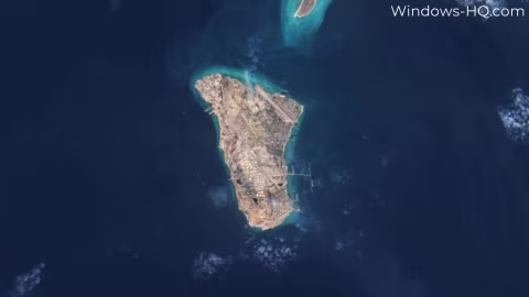 Satellite view showing a large, arid island and surrounding blue ocean water.