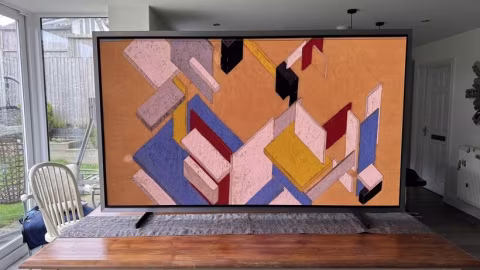 A modern abstract artwork featuring geometric shapes in orange, blue, and red tones.