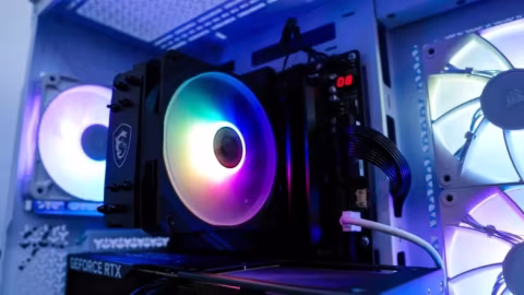 Close-up of a computer component build showing a large CPU cooler and graphics card.