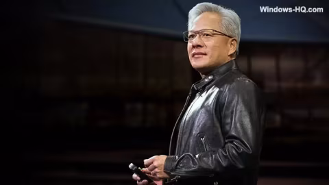 Older man with glasses and gray hair standing on stage, looking forward.