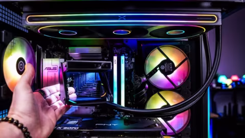Internal view of a computer case showing components, fans, and RGB lighting.