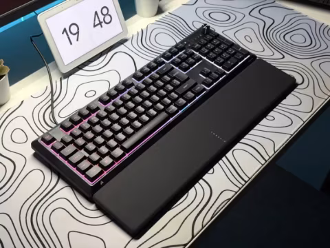 A black mechanical keyboard and a digital time display showing the time 19:48.