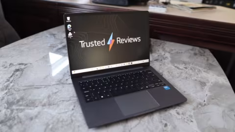 Open laptop displaying "Trusted Reviews" on the screen, resting on a white marble surface.