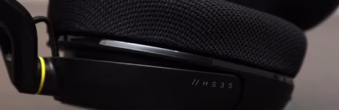 Close-up view of a black over-ear headset featuring a textured earcup and the visible model marking // HS 3 5.