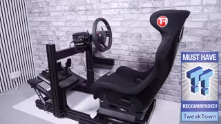 Black simulator racing cockpit featuring an attached steering wheel, seat, and pedal mounting system.