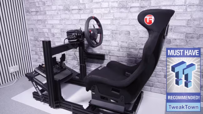 Black simulator racing cockpit featuring an attached steering wheel, seat, and pedal mounting system.