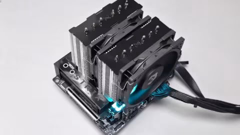 A large black dual-tower CPU cooler heatsink featuring multiple fins and two attached fans, displayed on white.